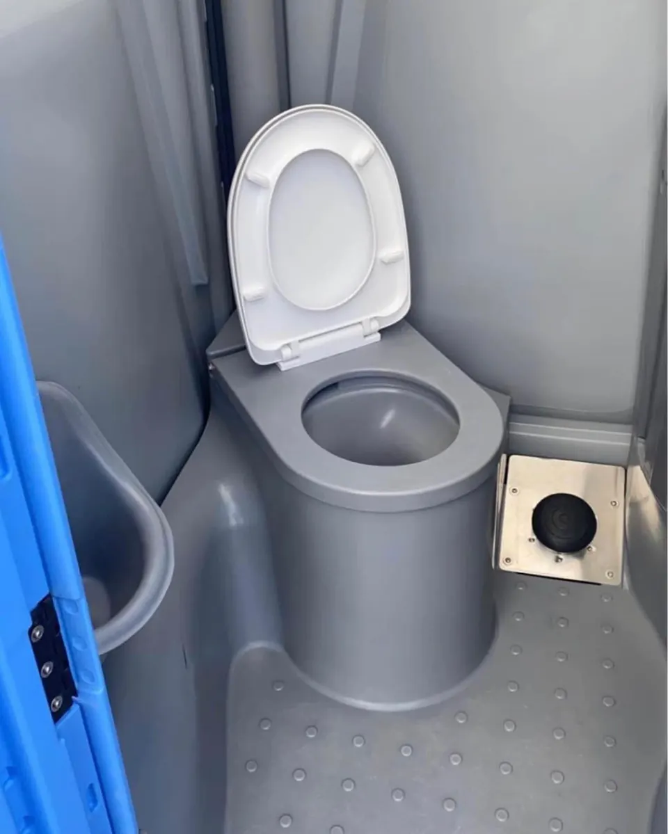 Portable restroom interior with toilet and compact sink