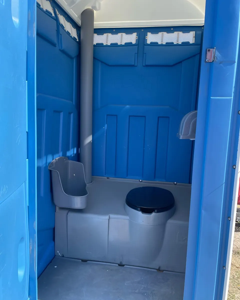 Blue portable toilet interior with urinal