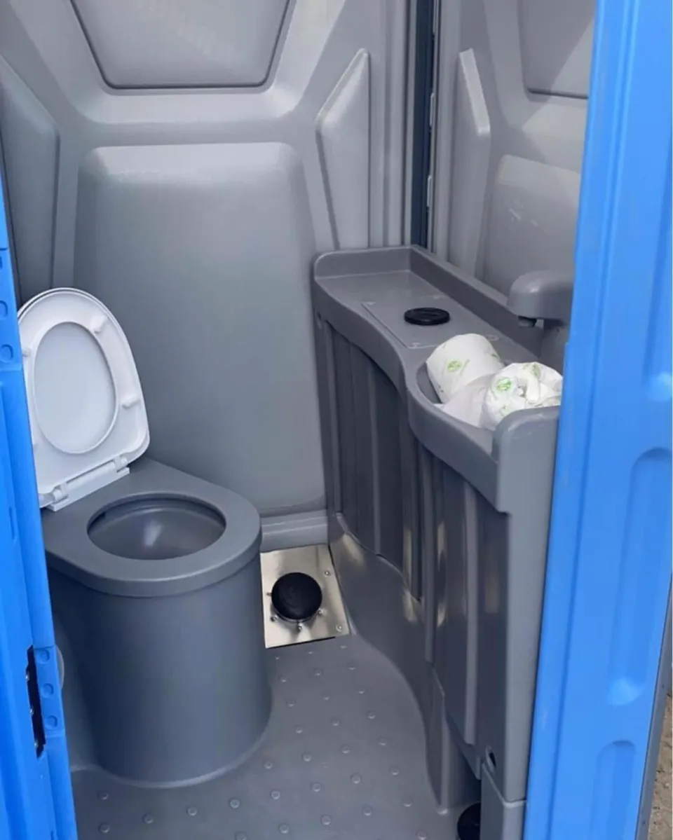 Portable restroom interior with toilet, urinal and sink