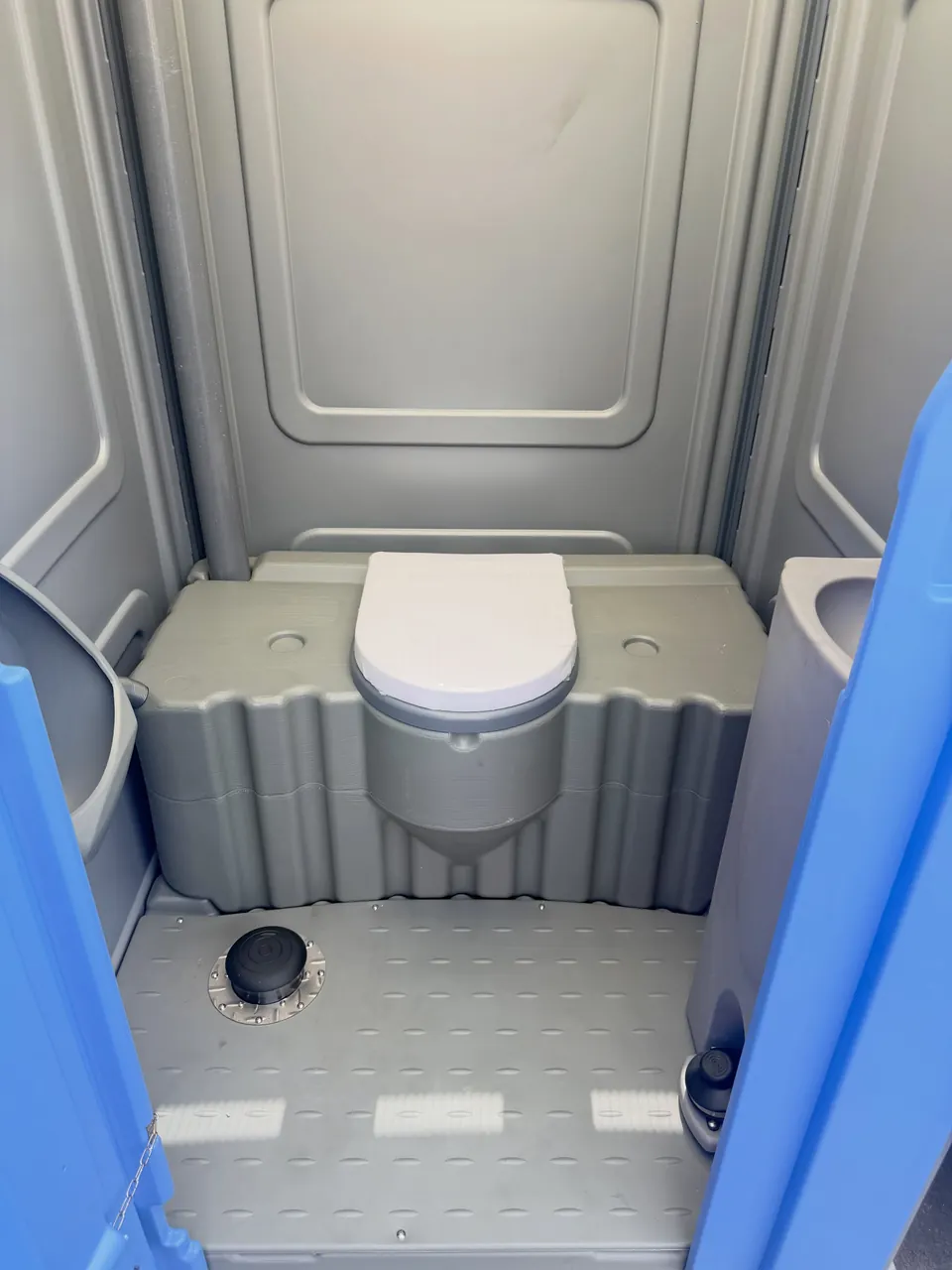 Portable restroom toilet and interior floor layout