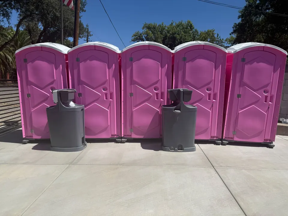 Pink portable toilets with separate handwashing stations