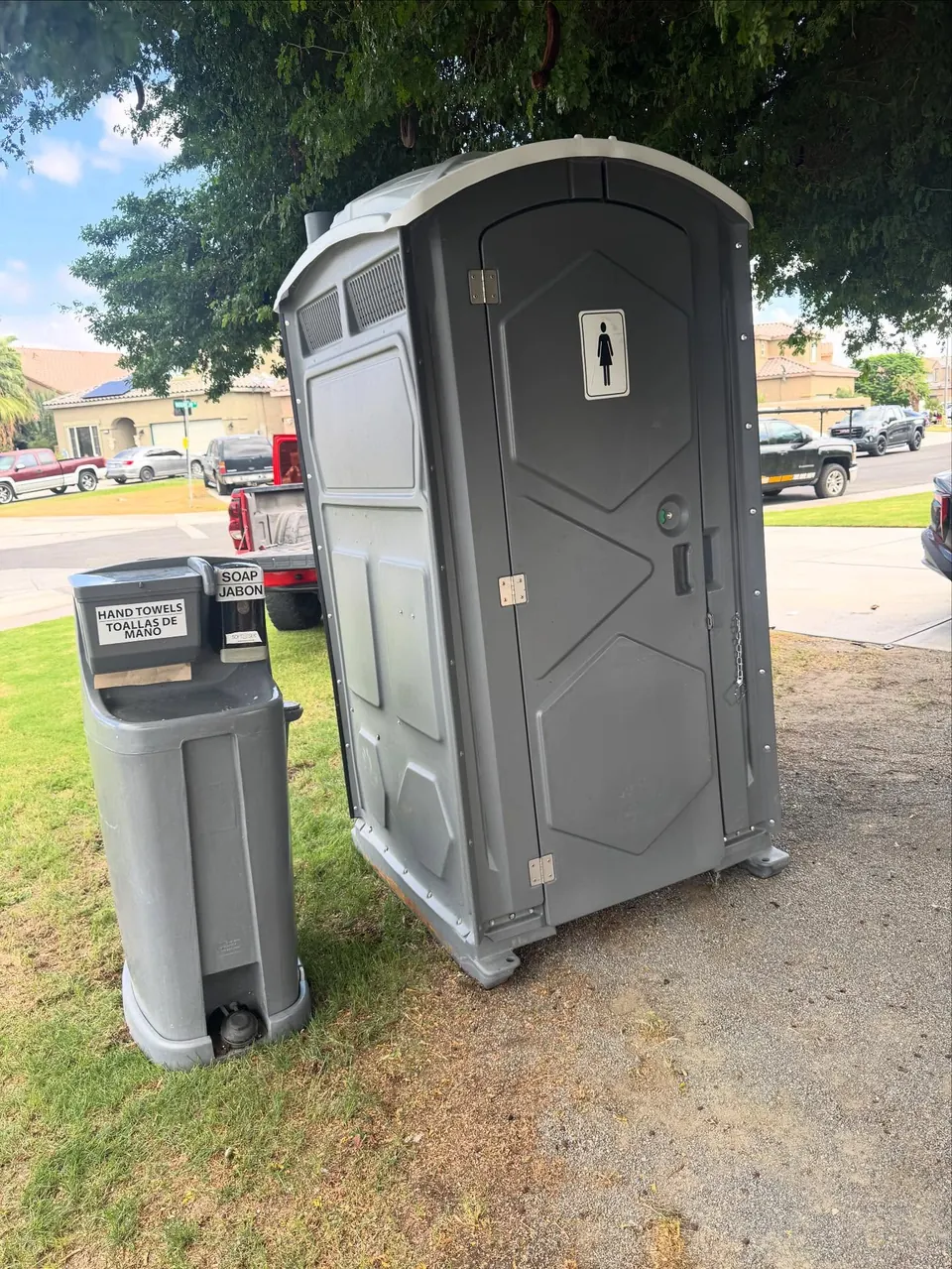 Portable toilet beside a separate handwashing station