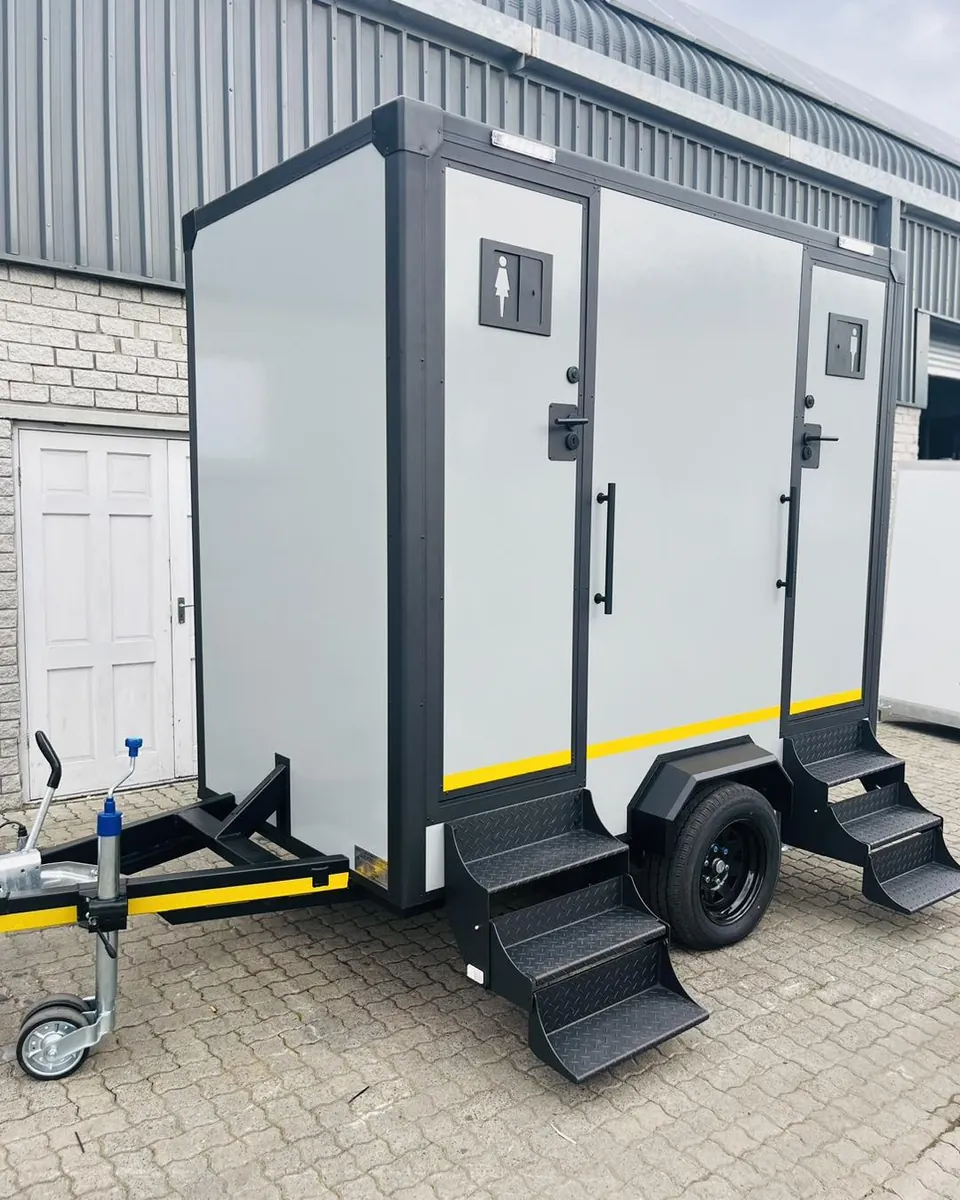 Two-door restroom trailer with entry steps